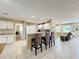 Bright kitchen with breakfast bar seating and white cabinets with stainless appliances at 4120 Shamrock Dr, Venice, FL 34293