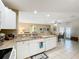 Well-lit kitchen with granite counters, white cabinets, and open to the dining area at 4120 Shamrock Dr, Venice, FL 34293