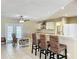Bright kitchen with bar seating, white cabinets, and stainless steel appliances at 4120 Shamrock Dr, Venice, FL 34293