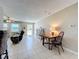 Cozy living area featuring a dining table and sitting area with neutral-toned tile at 4120 Shamrock Dr, Venice, FL 34293