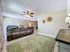 Relaxing living room features a large couch, overhead fan, and tan paint at 4120 Shamrock Dr, Venice, FL 34293