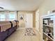 Cozy living room with tile floors, a comfortable couch, and natural light from the windows at 4120 Shamrock Dr, Venice, FL 34293