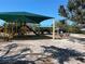 Community playground featuring a covered playset area with slides and other play equipment at 4120 Shamrock Dr, Venice, FL 34293
