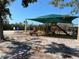 Community playground featuring a covered playset area with slides and other play equipment at 4120 Shamrock Dr, Venice, FL 34293