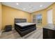 Bedroom with a ceiling fan, and laminate floors, with a black, white, and gray mattress set on a gray frame at 4331 Turnberry Cir, North Port, FL 34288
