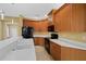Modern kitchen with white countertops, wood cabinets, and sleek black appliances at 4331 Turnberry Cir, North Port, FL 34288