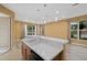 Bright kitchen features pendant lights, and a peninsula overlooking the living area with a sink and white countertops at 4331 Turnberry Cir, North Port, FL 34288