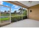 Relax on the lanai with views of the pond, palm trees, and lush landscaping at 4331 Turnberry Cir, North Port, FL 34288
