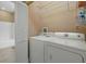 Laundry room with a stacked washer and dryer next to a closet at 4331 Turnberry Cir, North Port, FL 34288