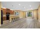 Spacious living room with wood floors and large windows offering a view of lush landscaping at 4331 Turnberry Cir, North Port, FL 34288