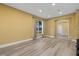 Spacious living room with wood floors and large windows offering a view of lush landscaping at 4331 Turnberry Cir, North Port, FL 34288