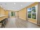 Spacious living room with wood floors and large windows offering a view of lush landscaping at 4331 Turnberry Cir, North Port, FL 34288