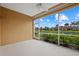 Patio with screened windows overlooks a beautiful pond with palm trees and other vegetation at 4331 Turnberry Cir, North Port, FL 34288