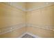 A walk-in closet includes a floor and wall with metal shelves at 4331 Turnberry Cir, North Port, FL 34288