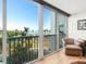 Balcony view showcasing waterfront views, lush greenery, and a peek of the water at 435 S Gulfstream Ave # 601, Sarasota, FL 34236
