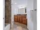 Cozy bathroom features dark cabinets, shower with decorative tile work, and neutral colors at 435 S Gulfstream Ave # 601, Sarasota, FL 34236