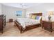 Inviting bedroom with wood furniture, soft bedding, and a bright window offering serene waterfront views at 435 S Gulfstream Ave # 601, Sarasota, FL 34236