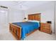 Bedroom with plush blue comforter, white walls, and a ceiling fan at 435 S Gulfstream Ave # 601, Sarasota, FL 34236
