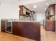 Well-appointed kitchen featuring granite countertops, custom wood cabinets, stainless steel appliances, and wine cooler at 435 S Gulfstream Ave # 601, Sarasota, FL 34236