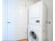 Laundry area showcasing a stacked washer and dryer unit and a white door at 435 S Gulfstream Ave # 601, Sarasota, FL 34236