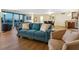 Open-concept living room with a blue sofa, neutral armchairs, and water views at 435 S Gulfstream Ave # 601, Sarasota, FL 34236