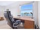 Office featuring a large window with palm tree views and a comfortable chair at 435 S Gulfstream Ave # 601, Sarasota, FL 34236