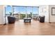 Inviting seating area with comfortable chairs, a glass coffee table, and floor-to-ceiling windows at 435 S Gulfstream Ave # 601, Sarasota, FL 34236