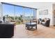 Cozy sitting area with plush chairs, center table, and views of the waterfront from the balcony at 435 S Gulfstream Ave # 601, Sarasota, FL 34236