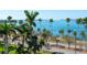 Expansive waterfront view with palm trees and boats on the water from the balcony at 435 S Gulfstream Ave # 601, Sarasota, FL 34236