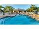 Community pool, clubhouse and lounge chairs perfect for relaxation and socializing, enhancing the community's appeal and lifestyle at 4406 Turnberry Ct, Bradenton, FL 34210