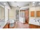 Bathroom with glass block accents, soaking tub and walk-in shower at 4901 Sabal Lake Cir, Sarasota, FL 34238