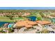 Stunning aerial view of the community clubhouse, pool, and golf course at 4909 Clubview E Ct, Bradenton, FL 34203