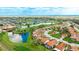 Aerial view of a golf course community with manicured landscaping and sparkling water features at 4909 Clubview E Ct, Bradenton, FL 34203