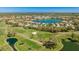 Stunning aerial view of the golf course community featuring lush fairways and serene waterfront homes at 4909 Clubview E Ct, Bradenton, FL 34203