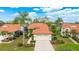 Aerial view of a lovely single Gathering home with a two car garage, lush landscaping and orange tile roof at 4909 Clubview E Ct, Bradenton, FL 34203