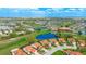 Wide aerial shot of a golf course community, featuring ponds, lush trees, and manicured landscaping at 4909 Clubview E Ct, Bradenton, FL 34203