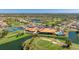 Aerial view showcasing the golf course, clubhouse, pool, and surrounding residential community at 4909 Clubview E Ct, Bradenton, FL 34203