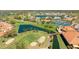 Beautiful aerial view of the community, showcasing the golf course, tennis courts, and serene waterfront homes at 4909 Clubview E Ct, Bradenton, FL 34203