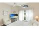 Cozy bedroom with TV, comfy chair, and views of the lush outdoors at 4909 Clubview E Ct, Bradenton, FL 34203