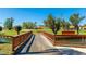Wooden bridge over the water with beautiful landscaping and golf course in the background at 4909 Clubview E Ct, Bradenton, FL 34203
