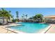 Beautiful community pool area with poolside seating and lush landscaping at 4909 Clubview E Ct, Bradenton, FL 34203