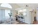 Bright dining area with barstool seating, a view to the kitchen, and lots of natural light at 4909 Clubview E Ct, Bradenton, FL 34203