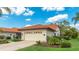 Charming home with a well-manicured lawn, two-car garage, and beautiful landscaping at 4909 Clubview E Ct, Bradenton, FL 34203