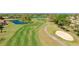 Scenic view of the golf course featuring lush green fairways, a meandering path, and a sand trap at 4909 Clubview E Ct, Bradenton, FL 34203