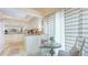 Sunlit kitchen with granite countertops, white cabinetry, and a cozy breakfast nook at 4909 Clubview E Ct, Bradenton, FL 34203