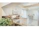 Bright kitchen featuring granite countertops, white cabinetry, and stainless steel appliances at 4909 Clubview E Ct, Bradenton, FL 34203