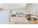 Well-lit kitchen featuring granite countertops, white appliances, and ample cabinet space at 4909 Clubview E Ct, Bradenton, FL 34203