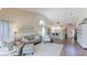 Open-concept living room with hardwood floors, neutral decor, and an abundance of natural light at 4909 Clubview E Ct, Bradenton, FL 34203
