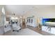 Open-concept living room with high ceilings, white trim, and hardwood floors with modern furnishings at 4909 Clubview E Ct, Bradenton, FL 34203