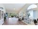 Bright living room with hardwood floors, neutral paint, modern furnishings, and a sliding glass door to the lanai at 4909 Clubview E Ct, Bradenton, FL 34203